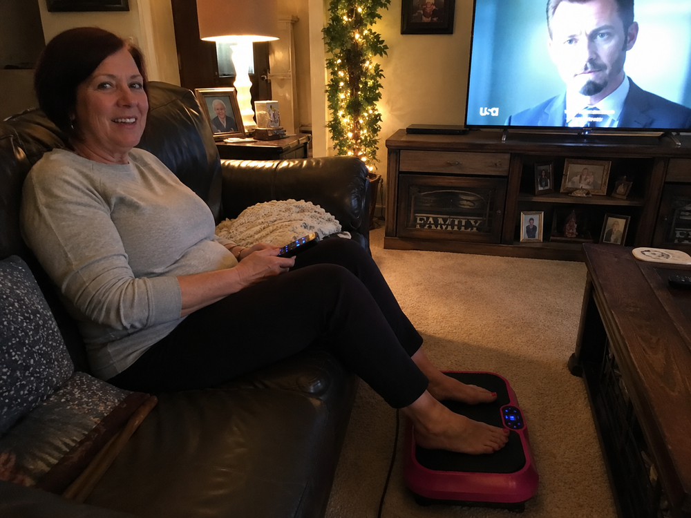 Woman relaxing in her armchair with her feet resting on the Nuvé plate